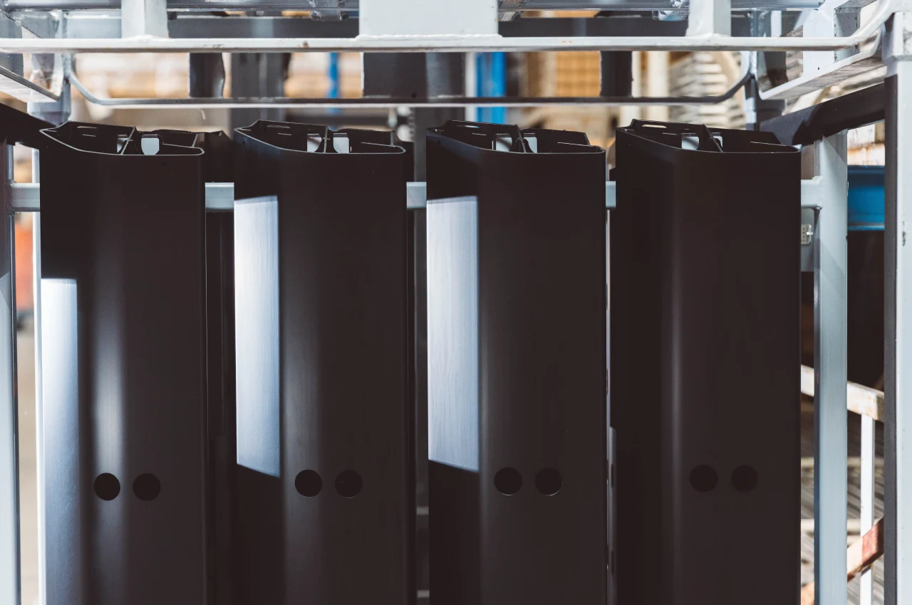 Black-finished aluminium components on racks