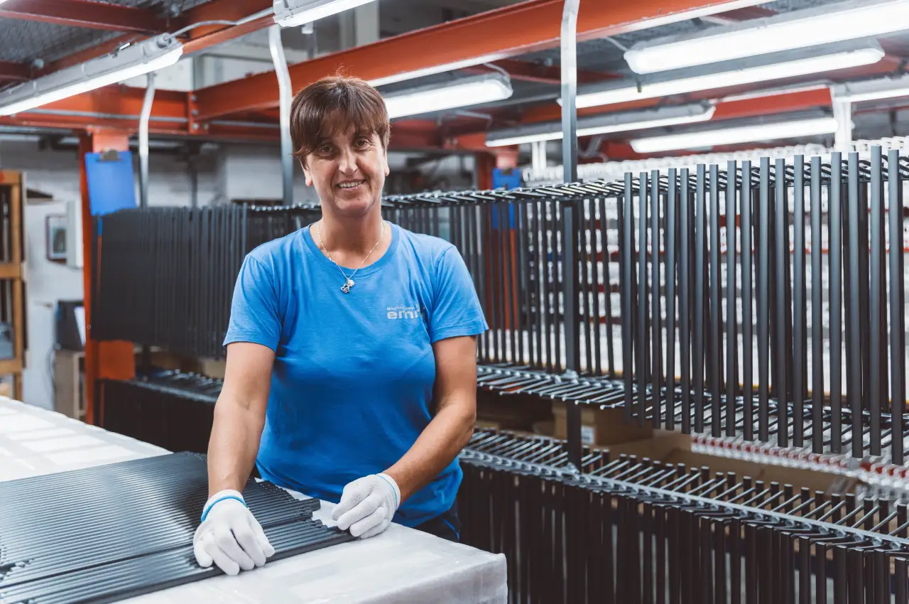 Operator hanging aluminium components before surface treatment
