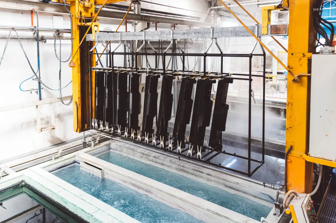 Hoist lowering aluminium components into a process tank