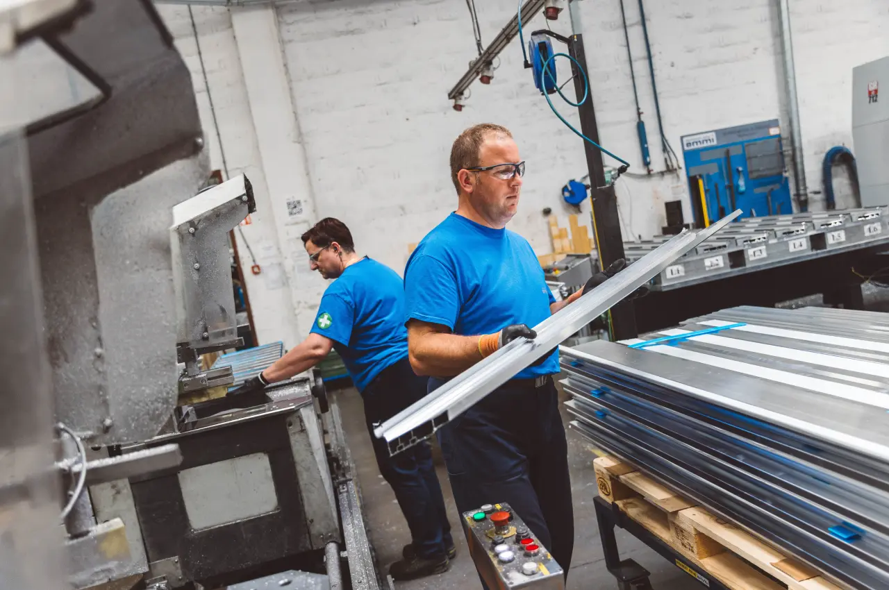 Operator machining a long aluminium profile